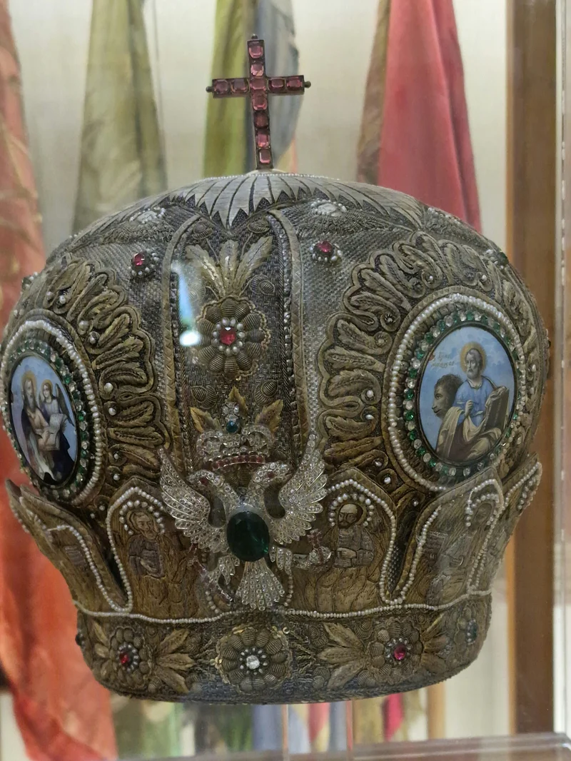 Embroidery, stones, icons around the sides and a cross on top: the mitre of Metropolitan Chrysostom of Smyrna. National Historical Museum, Athens