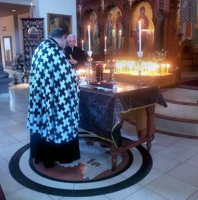 Holy Unction on Great Wednesday: the priest at the table with oil and candles. Greek cathedral in Toronto, 2017