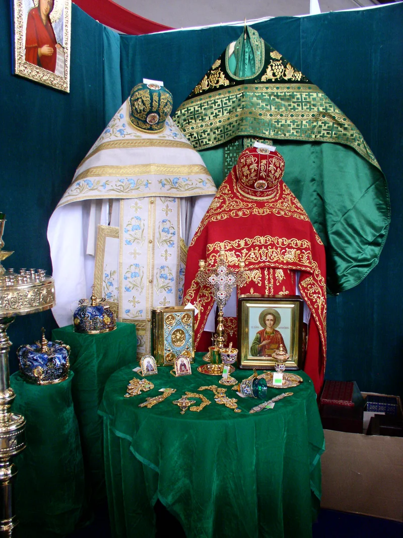 Phelonia of three colours side by side: white-and-blue, red and green. Church exhibition in Minsk