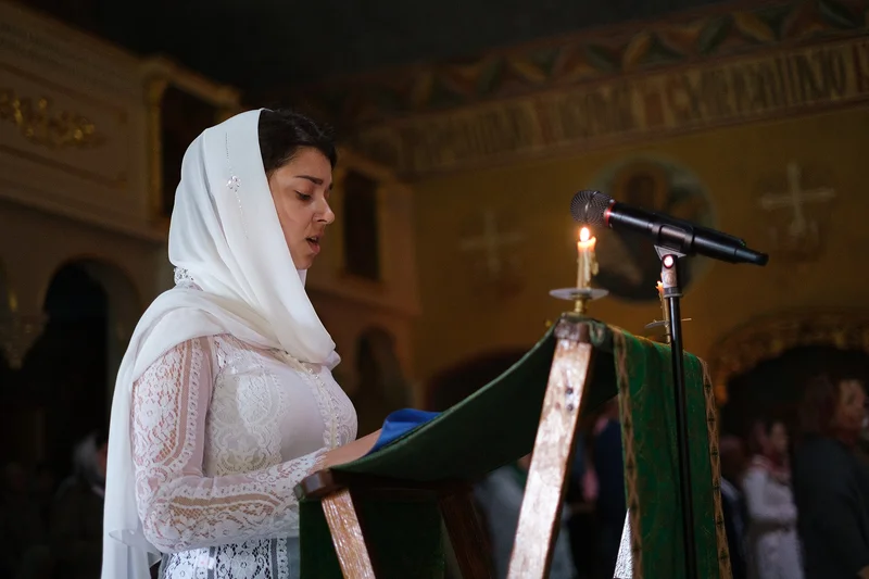 Reading an akathist at the analogion with a candle. Intercession church of the Moscow Theological Academy, 2020