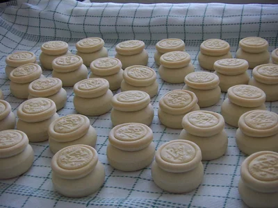 Freshly baked prosphora: the lower loaf with the stamped upper part set on it