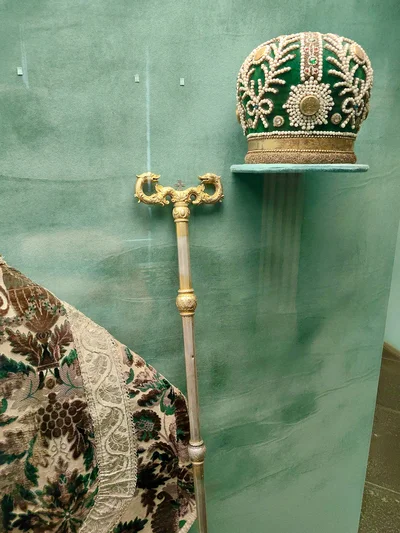 A Russian mitre with pearl embroidery, displayed beside a bishop's staff. Rostov Kremlin