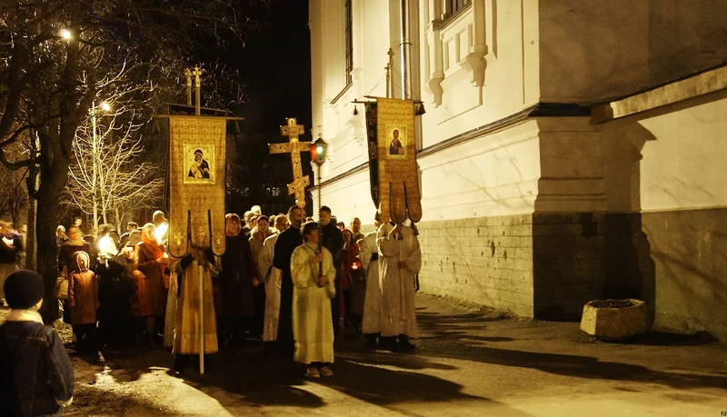 The night procession with banners and candles around the Protection cathedral