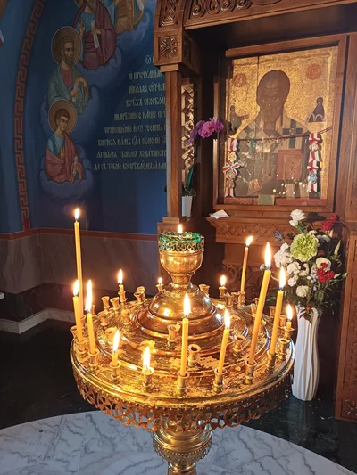 A candle stand before an icon in its case. Hagia Sophia church, Warsaw