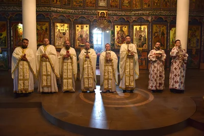 Clergy with candles in the middle of the church before the iconostasis. Holy Trinity Cathedral, Vranje, Serbia, 2018