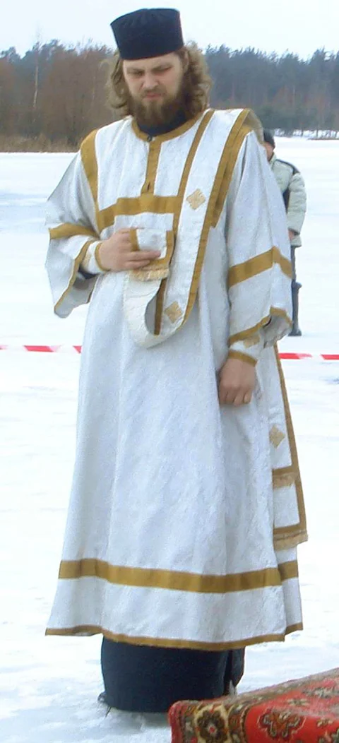 A monk in the rank of deacon: sticharion, orarion on the left shoulder and a monastic skufia. Theophany blessing of waters, 2011
