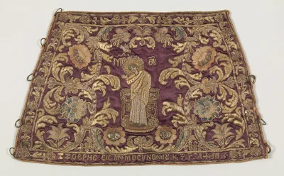 A cuff laid out flat: the loops along the edges are laced under the wrist. Metropolitan Museum of Art