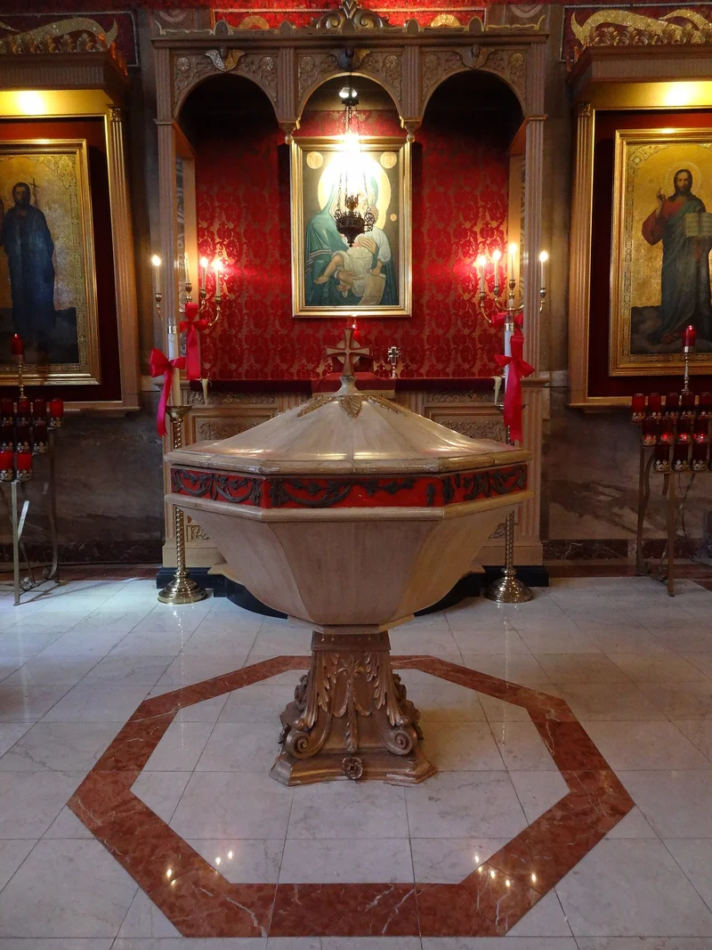 A large font on a carved base standing before the icons. Greek Transfiguration church, Lowell, Massachusetts