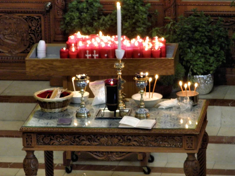 The table for Holy Unction: the vessel of oil, burning candles and the anointing sticks. Toronto, 2013