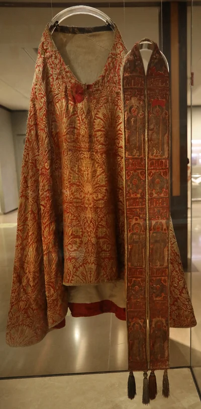 A Greek orarion of the 16th–17th century embroidered with saints and six-winged seraphim, shown beside a phelonion
