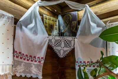 A home icon corner hung with embroidered towels. Ovsyanka village, Krasnoyarsk Krai