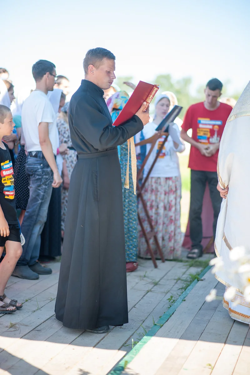 Reading the Epistle at an open-air service, 2017