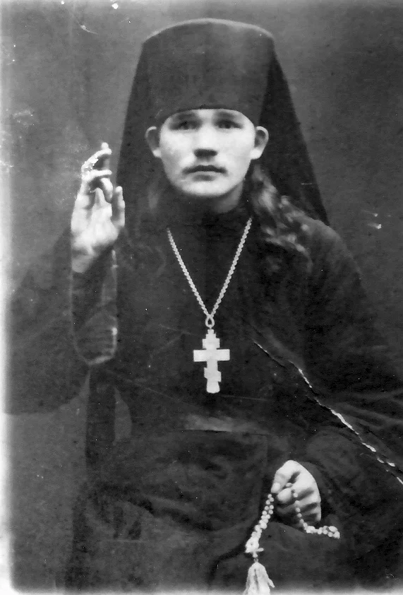 Black klobuk, cassock, prayer rope and pectoral cross: a monastic priest outside the service. Photograph before 1918