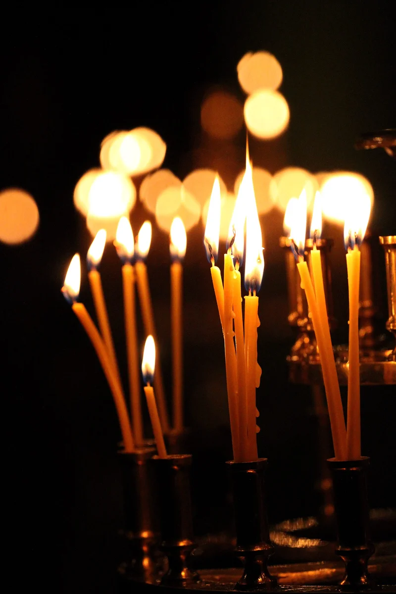Beeswax candles burning in a church candlestick