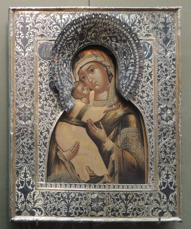 A copy of the Vladimir icon, early 17th century, in a silver riza of the late 18th century, which leaves only the faces and hands uncovered. Tretyakov Gallery