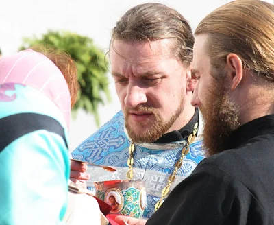 Close up: the chalice, the spoon and the cloth held under the communicant's chin. Zimne monastery, 2010