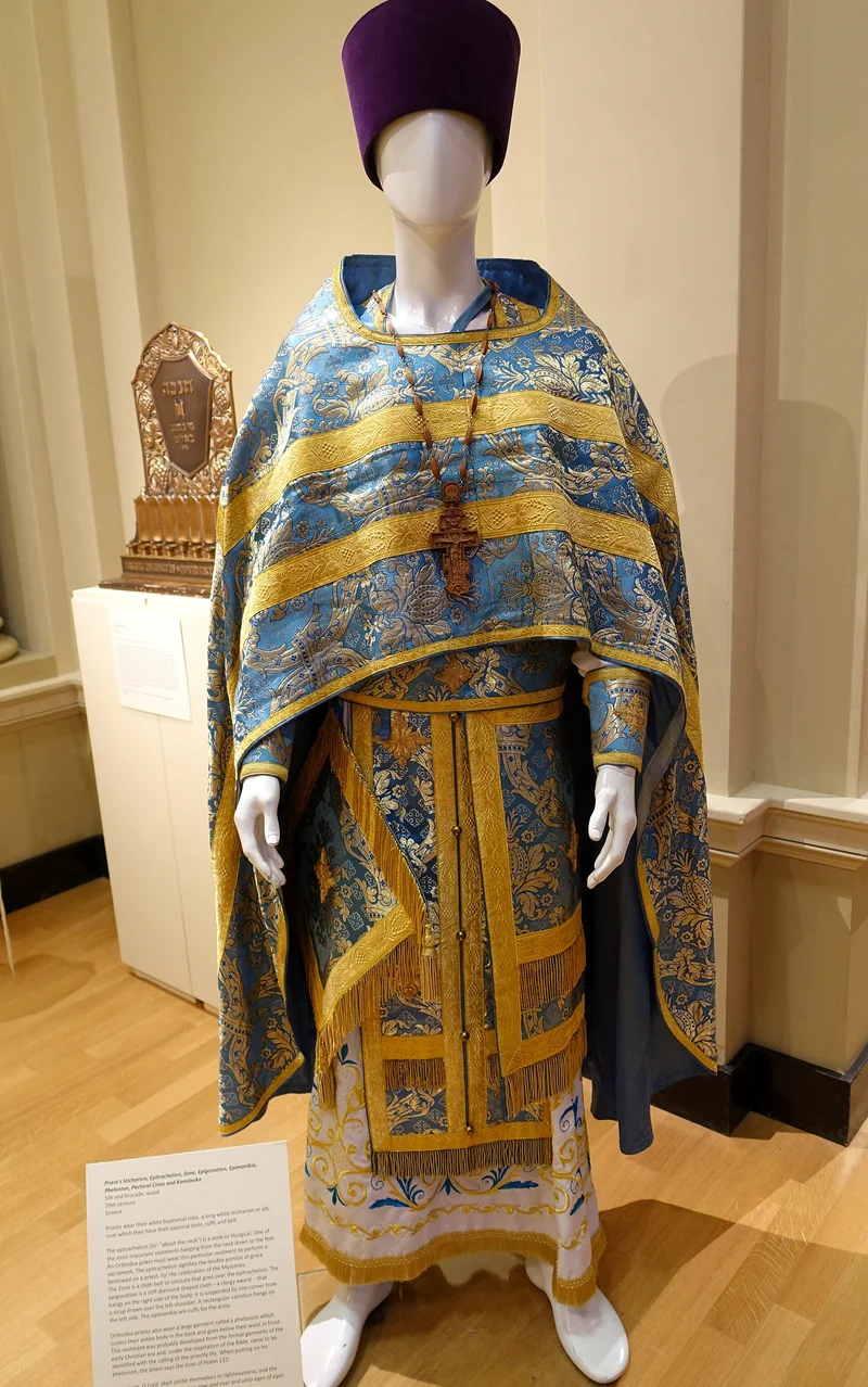 A complete 20th-century priest's vesting: phelonion, fringed epitrachelion, pectoral cross and kamilavka. St Ignatius Church, San Francisco