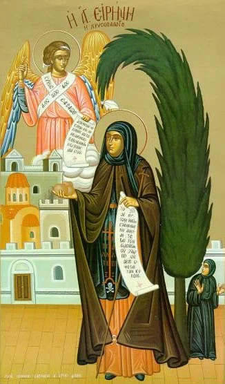 Икона с надписью «SAINT IRENE ... CHRYSOVOLANTOS», держащая чётки и крест, с ангелом и кипарисом на фоне