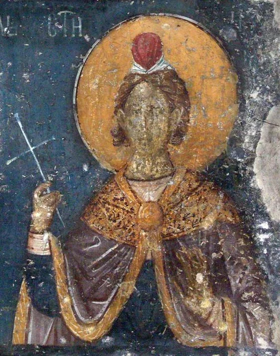 Фреска (Афон, Протат, ок. 1290, Мануил Панселин) с изображением святого в красном головном уборе, с крестом в руке — частично видна надпись